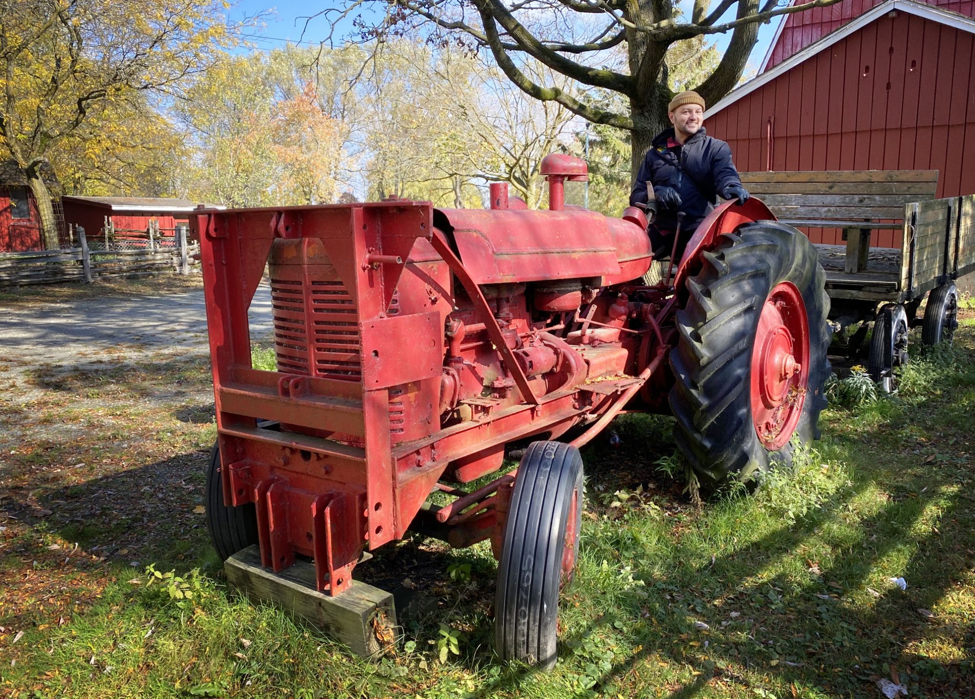 Simon Devost on a vintage tractor, on a crips autumn day.